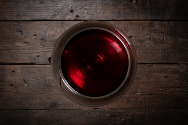 Red wine in wineglass on a gray background