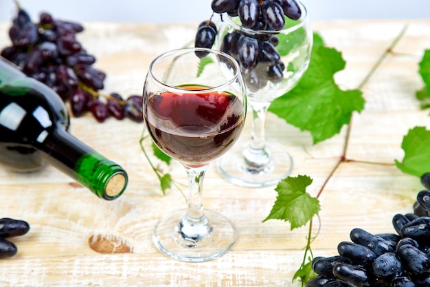 Red wine  with bottle, glass and grapes.