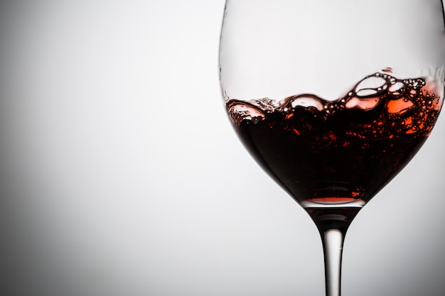 Red wine with bubbles in wineglass