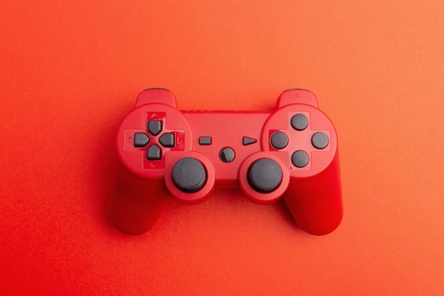 red wireless gamepad on red background