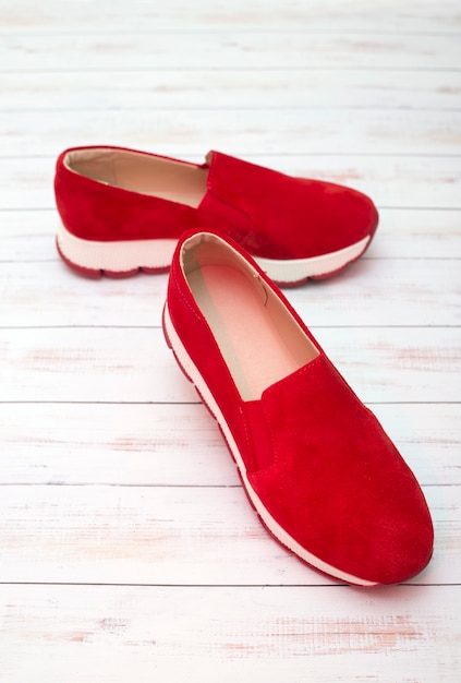 Red Women's sneakers on a wooden surface