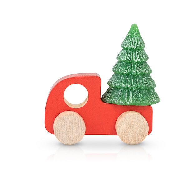 Red wooden car carrying a Christmas tree isolated on white background