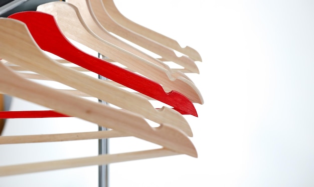 Red and wooden hanger hanging on metal