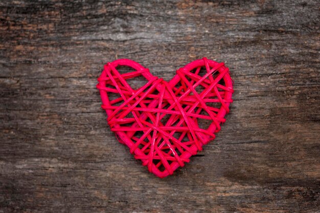 Red wooden heart on wooden dark background