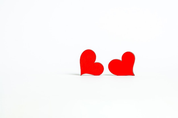 Red wooden hearts side by side look at each other