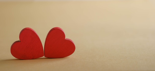 Red wooden hearts on a white surface