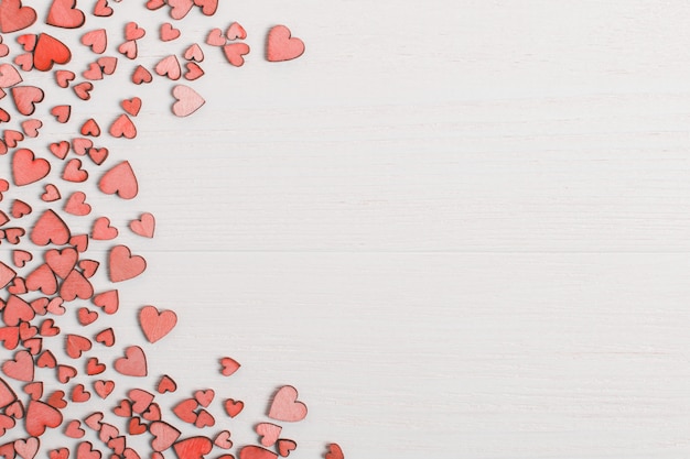 Red wooden hearts on a white table