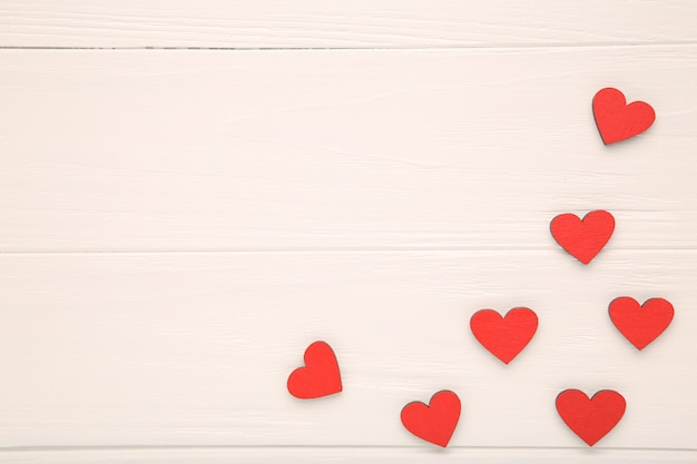 Red wooden hearts on wooden background