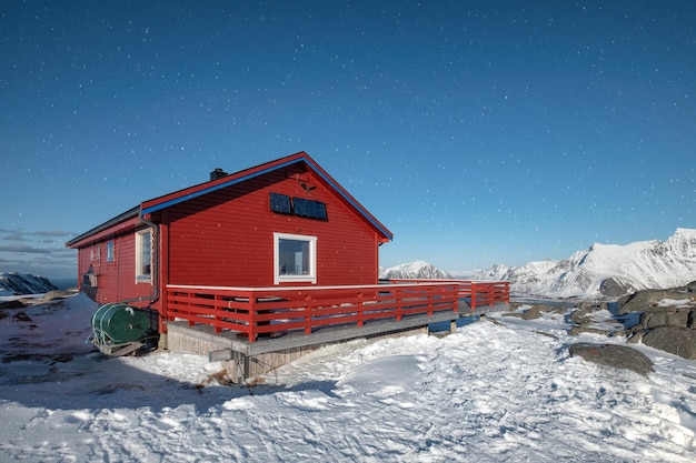 Red wooden lodge on top of snow hill in winter at Scandinavian countries Norway