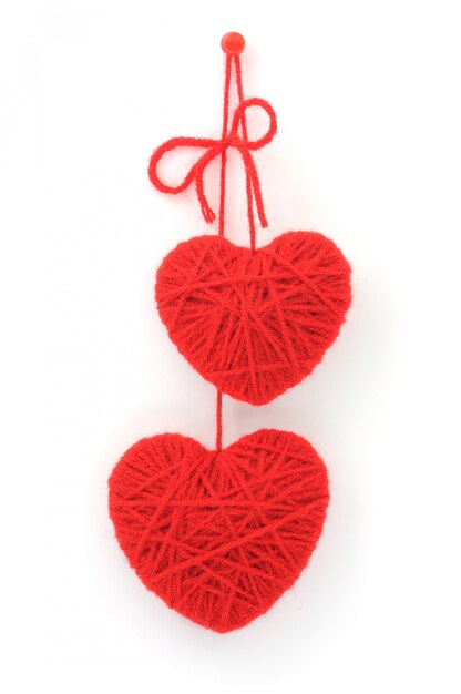 Red woolen hearts isolated on white background