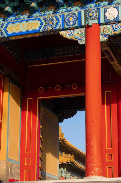 A red and yellow building with a blue sky in the background.