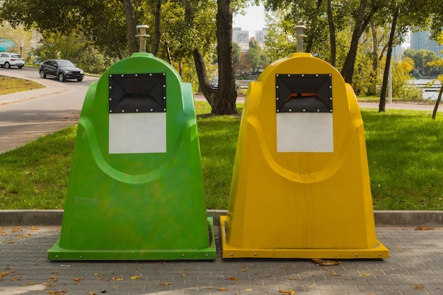 Red and yellow containers for waste sorting stand on the street Can Clean Junk Refuse Dustbin Nature Sorting City Park Different Eco Ecological Healthcare Public Safe Safety Health