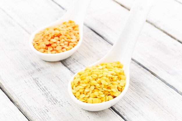 Red and yellow lentils on a  wooden background