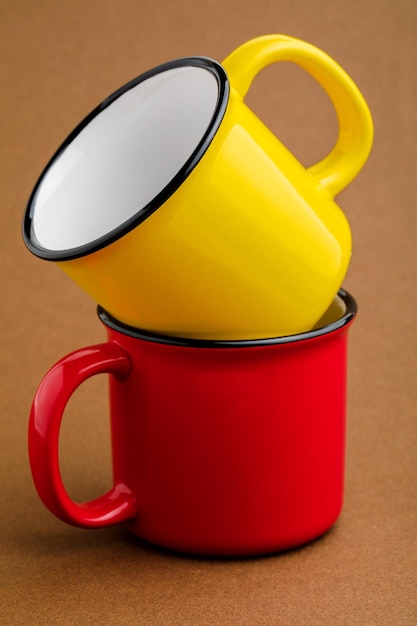 Red and yellow mug on brown background