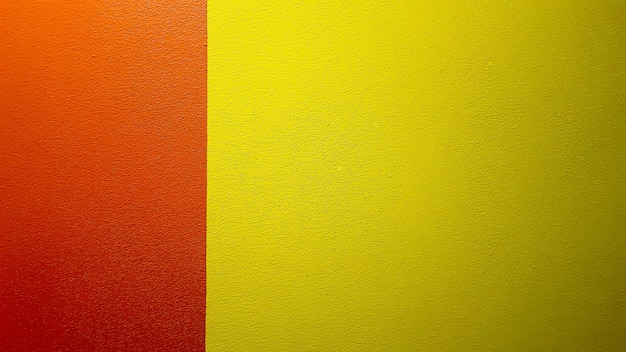 Red and yellow painted wall texture abstract grunge background with copy space. Abstract geometric pattern on the wall. The wall is divided into borders of different colors.