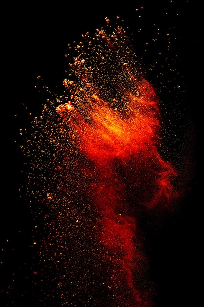 red yellow powder explosion on black background.