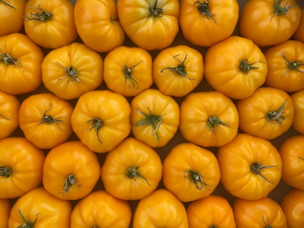 Red and yellow tomatoes in boxes at the farmers market.selective focus.nature