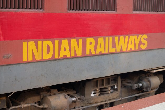 A red and yellow train with the words indian railway on the side