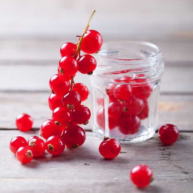 Redcurrant branch close to a glass jar