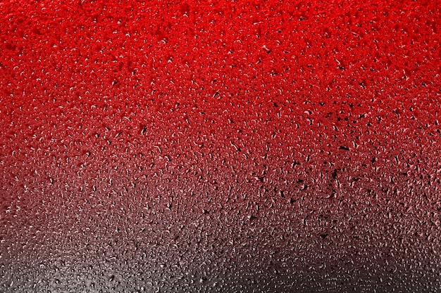 ドロップと赤く暗い表面デザインの抽象的な背景