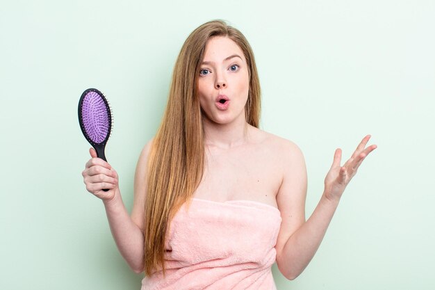 redhair woman feeling extremely shocked and surprised. hair comb concept