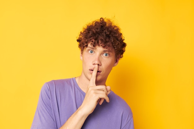 Redhaired curly guy in a purple tshirt gesture hands emotions