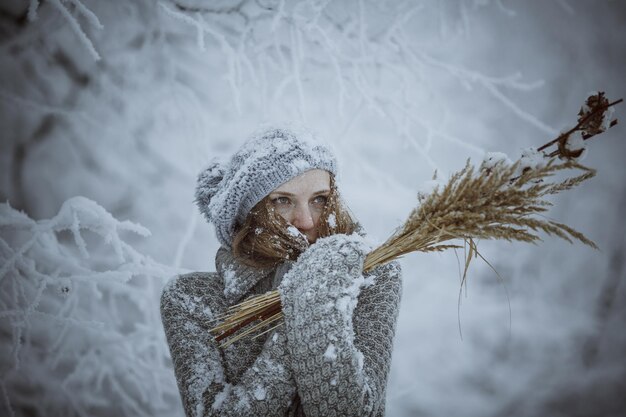 Redhaired girl in a beautiful snowy forest