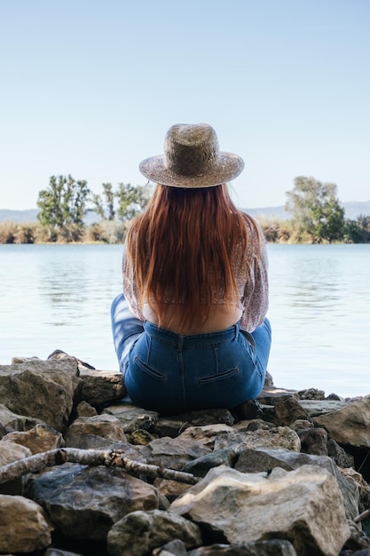 Redhaired girl looking at the river