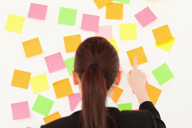 Redhaired woman taking a repositional notes