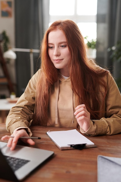 Redhaired Woman Working On School Project