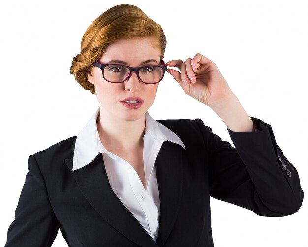 Redhead businesswoman touching her glasses