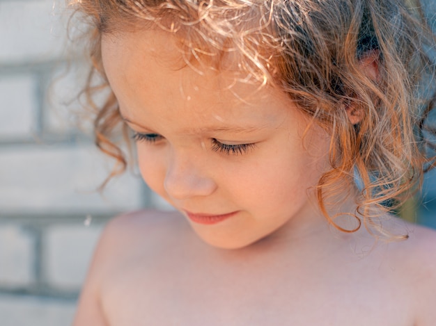 Redhead caucasian little girl portrait close-up.