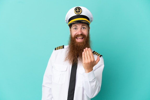 Redhead caucasian man playing rugby isolated on yellow background inviting to come with hand. Happy that you came