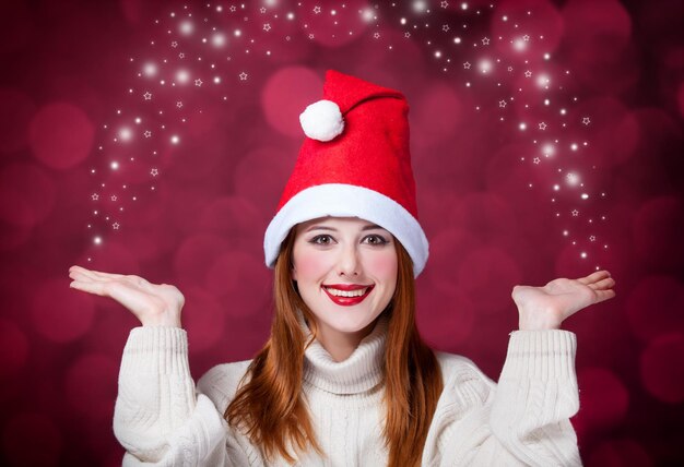 Redhead girl in christmas hat