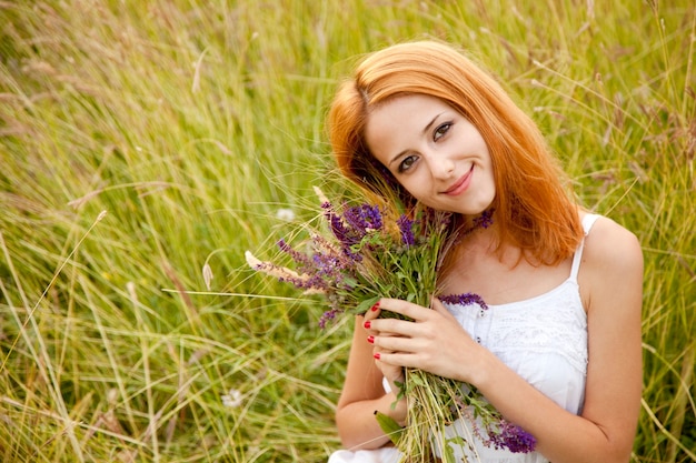 Redhead girl in meadow.