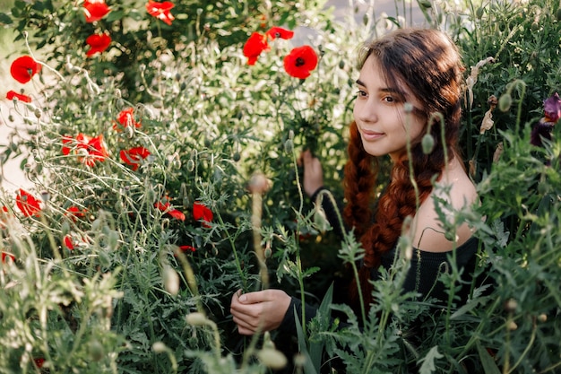 Redhead girl on a poppy field