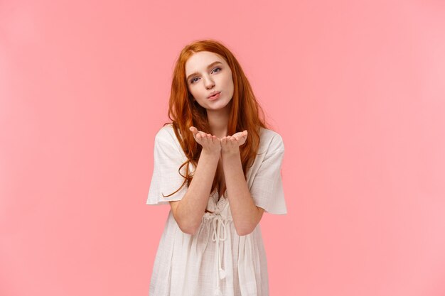 redhead girl sending blow kiss