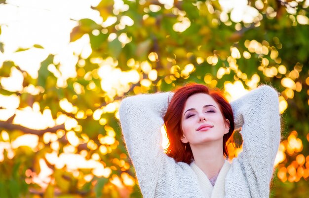 Redhead girl in style white cardigan