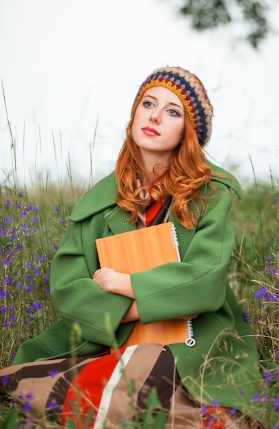 Redhead girl with note at outdoor