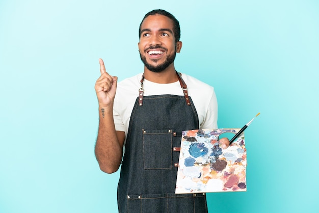 Redhead man over blue wall counting ten with fingers