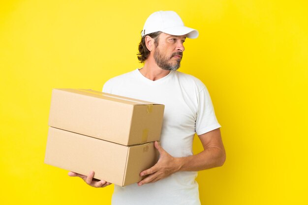 Redhead man over blue wall feeling upset