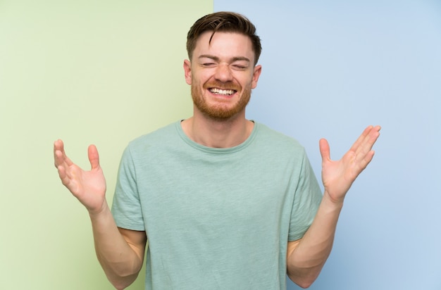 Redhead man over colorful laughing