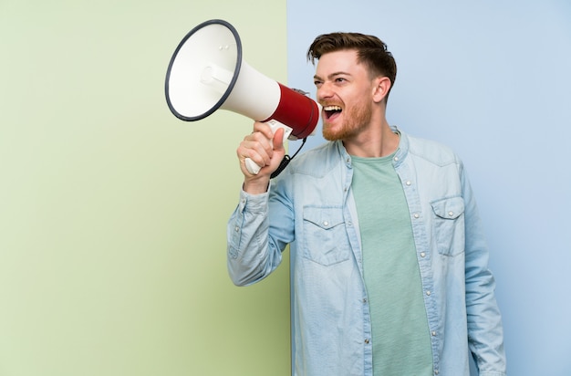 Redhead man shouting through a megaphone