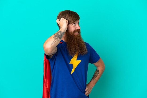 Redhead man in superhero costume and having doubts