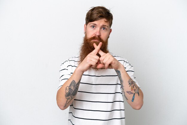 Redhead man with beard isolated on white background making stop gesture with her hand to stop an act