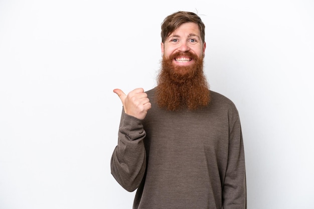 Redhead man with beard isolated on white background pointing to the side to present a product