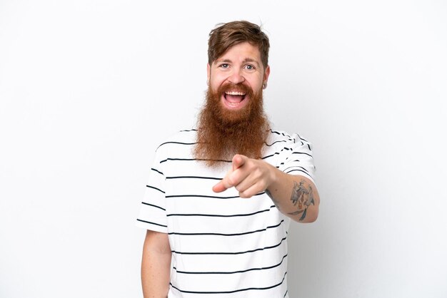 Redhead man with beard isolated on white background surprised and pointing front