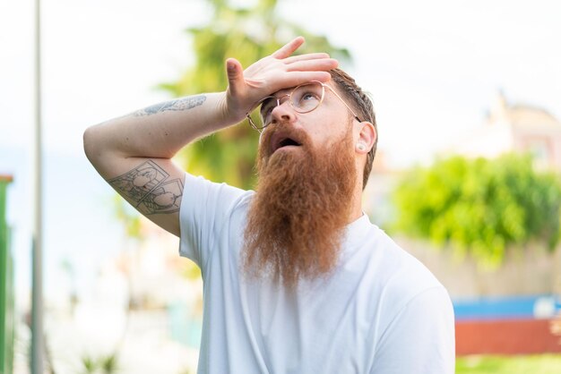 Redhead man with beard With glasses and tired