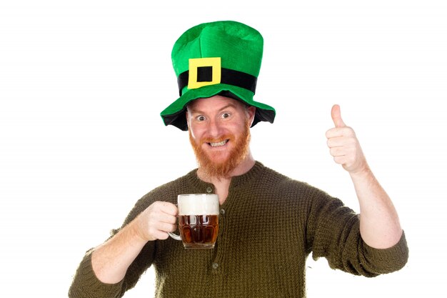 Redhead man with a big green hat drinking a beer