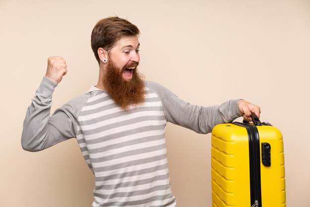 Redhead man with long beard holding a vintage briefcase